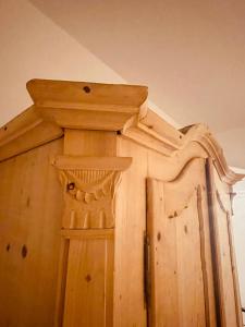 a wooden door with a wooden carving on it at Braunegg 1 in Brunico