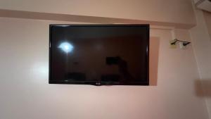 a flat screen tv hanging on a wall at Hotel Cosmos in Athens
