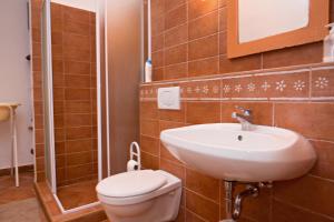 a bathroom with a sink and a toilet at Barta Pince Vendégház Mád in Mád