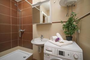 ein Badezimmer mit Waschmaschine und Waschbecken in der Unterkunft Villa Pia in Vodice + 20 Fotos