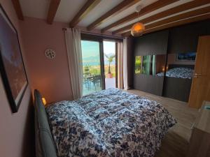 a bedroom with a bed and a large window at Palmito Villa in Baveno +39 photos