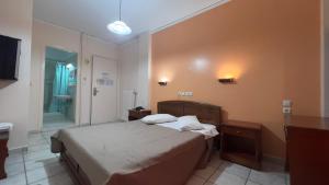 a bedroom with a bed and a bath room at Hotel Cosmos in Athens