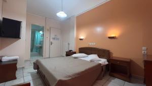 a bedroom with a bed and a television in it at Hotel Cosmos in Athens