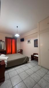 a bedroom with a bed and a tv in it at Hotel Cosmos in Athens