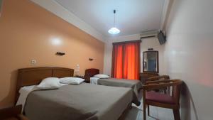 a hotel room with two beds and a window at Hotel Cosmos in Athens