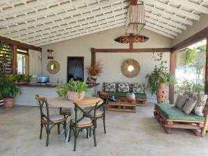 a living room with a table and chairs at Rio Da Barra Villa Hotel in Trancoso