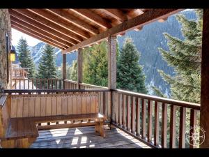 a large wooden balcony with a view of the mountains at CASA MARMOTA de Alma de Nieve in Baqueira-Beret