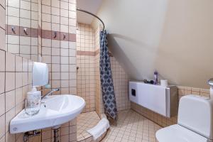 a bathroom with a sink and a toilet at Hotel Jelita in Nida +29 photos