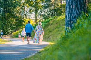 a man and a woman walking down a road at EuroParcs Zilverstrand in Mol