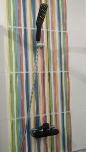 a shower curtain with a blow dryer on top at Forever São Brás in São Brás de Alportel