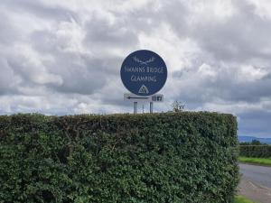 a sign for the swansridge garage channel at Swanns Bridge Glamping in Limavady