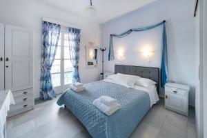 a bedroom with a bed with towels on it at Naxos Cave Suites in Stelida