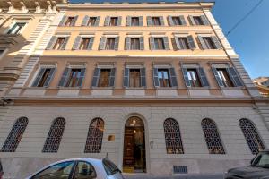 a building with a car parked in front of it at Sentho Roma in Rome