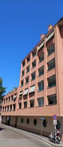 a large brick building with a scooter parked in front of it at 6 a casa in Milan