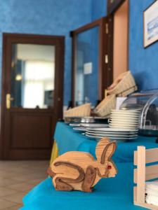 a wooden figurine of a rabbit on a table at Hotel Zodiaco in Bolsena