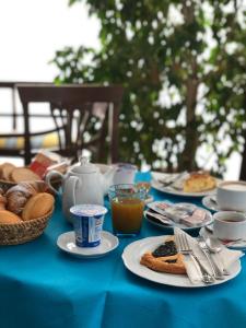 a blue table topped with plates of food and drinks at Hotel Zodiaco in Bolsena