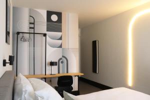 a bedroom with a bed and a desk in it at Hotel National Antwerp in Antwerp