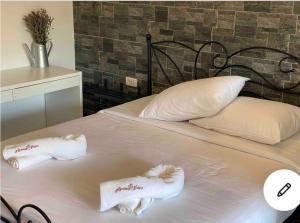 a white bed with two towels on top of it at Lovely apartment in nature with infrared sauna! in Postojna