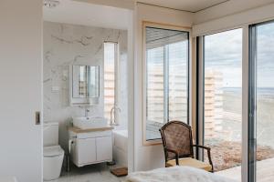 a bathroom with a sink and a toilet and a window at One Tree Hill Wilson prom and Ocean views in Toora +35 photos