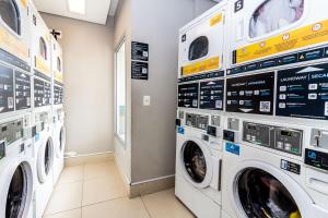 a laundry room with two washing machines in a store at 360 Expo Center in Sao Paulo