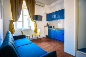 a living room with blue cabinets and a blue couch at LE MURA OLD TOWN APARTMENT by DuHomes in Dubrovnik