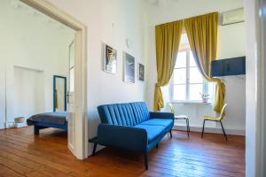 a living room with a blue couch and a table at LE MURA OLD TOWN APARTMENT by DuHomes in Dubrovnik