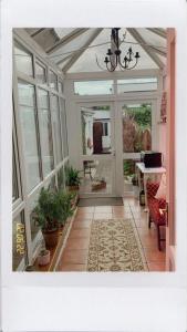 a screened in porch with a chandelier at Donnybrook Hall in Dublin