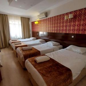 a row of beds in a hotel room at CLASS 17 PANSİYON in Çanakkale