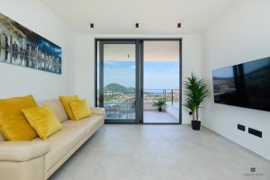 a living room with a couch and sliding glass doors at Hedera Estate, Hedera A28 in Dubrovnik