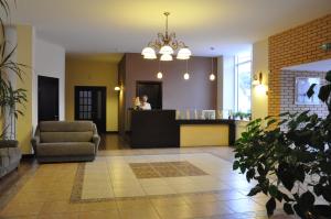 a lobby with a bar and a woman in the background at Hotel-Restaurant Complex Vensky in Brovary