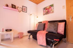 a living room with a couch with pillows on it at Haus Padrun 6 in Arosa