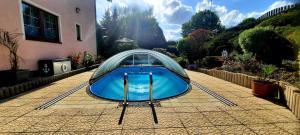 a swimming pool with a glass dome in a backyard at Pool Apartments in Karlovy Vary