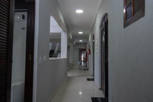 a hallway of a building with a long corridor at Pousada do Vladimir in Boracéia