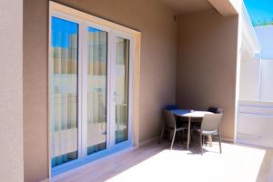 a dining room with a table and a glass door at Domina Apartments in Monopoli