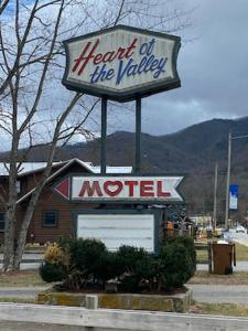a sign for the hottest of the valley motel at Heart of the Valley Motel in Maggie Valley