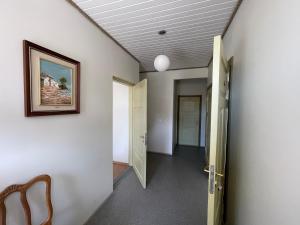 a hallway with a door leading to a room at Suur-Mere Guesthouse in Haapsalu