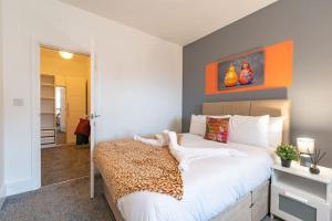 a bedroom with a white bed with a leopard blanket at Jesouth Refreshing 1 BedRM Condo Roomy Comfy Posh in Hull