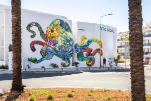 a wall with a painting of an octopus on it at Vila Maria Hotel - Adults Only in Albufeira