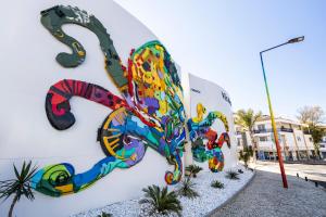 a painting on the side of a building at Vila Maria Hotel - Adults Only in Albufeira