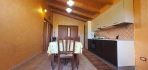 a kitchen with a table and chairs in a room at Cristian Apartaments in Capo Vaticano