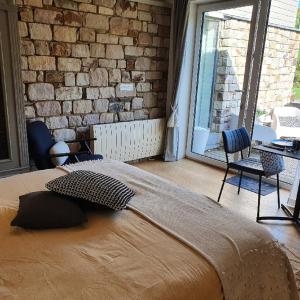 Letto o letti in una camera di B&B Maison Pierreuse