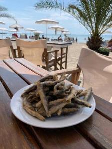 a plate of food sitting on a table at the beach at Studio in the center of Sarafovo in Burgas