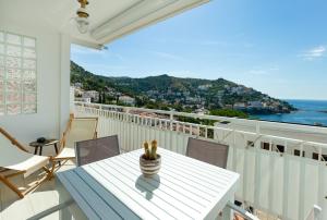 a balcony with a table and chairs and a view of the ocean at V014 - SANTA BARBARA in Roses