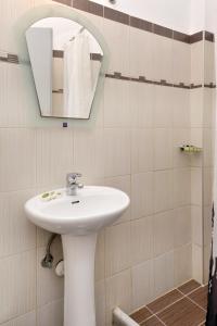 a bathroom with a sink and a mirror at Hotel Villa Plaza in Spetses