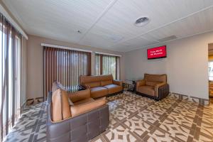 a waiting room with two couches and a tv at Red Roof Inn Dahlgren - Naval Base in Dahlgren