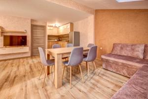 a kitchen and dining room with a table and chairs at Complex Hunter's Beach in Shkorpilovtsi