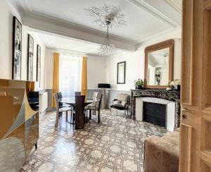a living room with a table and a fireplace at L'oiseau Bleu suite MERLE BLEU in Roubia +18 photos