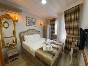 Habitación de hotel con cama y espejo en New Cherry Hotel, en Estambul