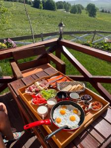 a tray of breakfast food on a wooden table at Etno selo Smrčevo brdo in Žabljak