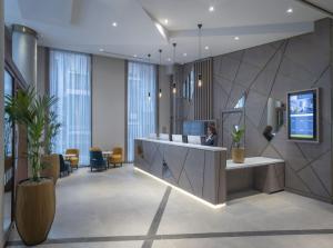 a lobby with a reception desk in a building at Maldron Hotel Manchester City Centre in Manchester